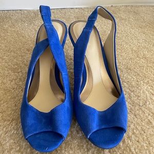 Blue Calvin Klein pumps heels shoes with a brown heel.